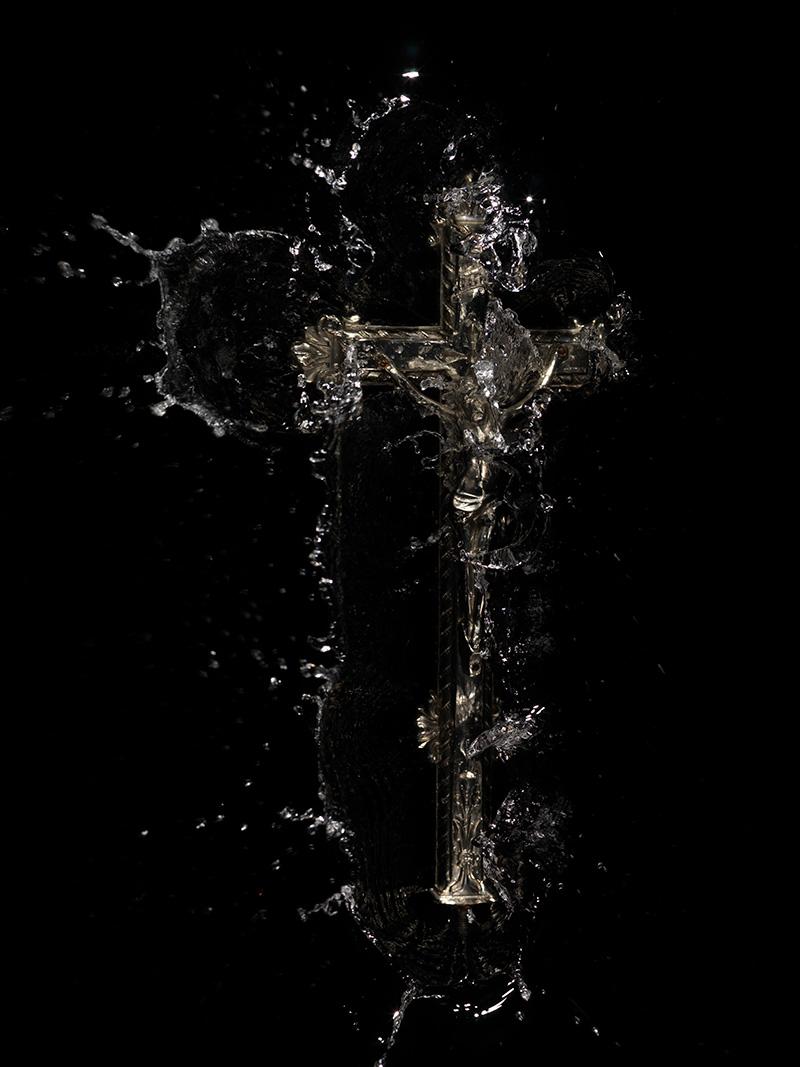 splash crucifixion cross is cast into water recreating a catholic religious scene