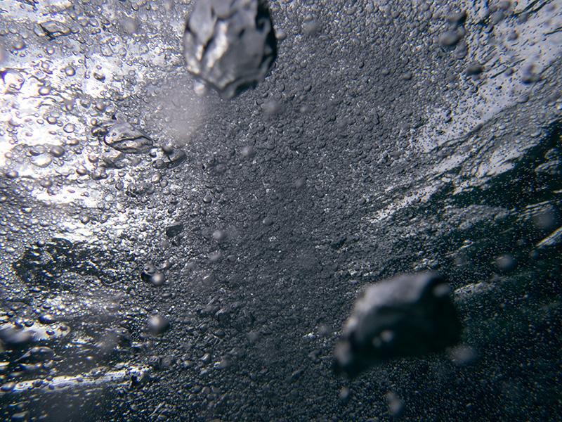 Underwater Reflections: Air Bubbles and Light Through Crystal Clear Blue Water